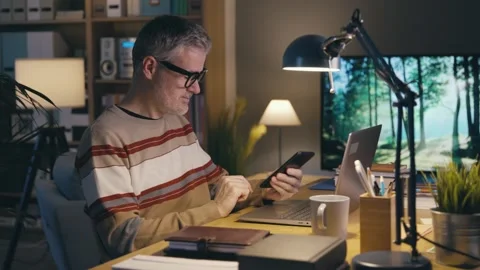 Man working from home and using devices Stock Footage 306126443