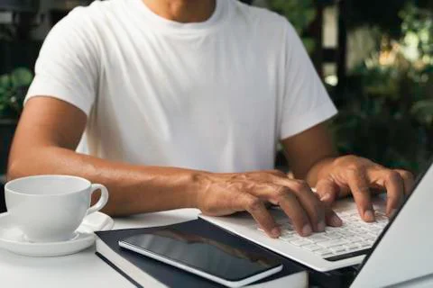 A man working at home and using laptop on the table. Technology and business  Foto stock