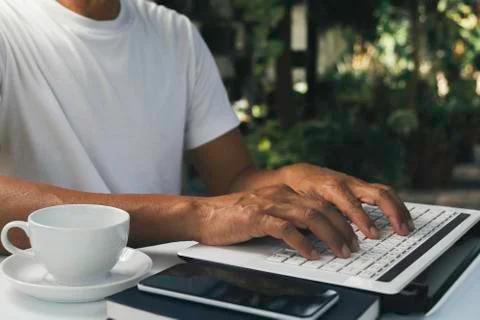 A man working at home and using laptop on the table. Technology and business  Foto stock