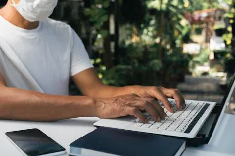 A man working at home and using laptop on the table. Technology and business  Stock Photos