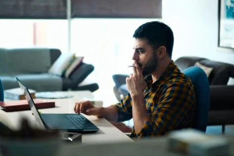 Man Working From Home With Computer And Smoking Cigarette Stock Photos