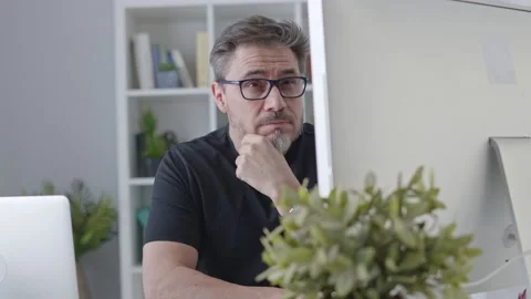 Man working home with desktop computer thinking Stock Footage 148022213