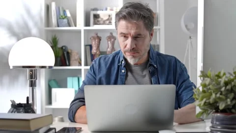 Man working home with desktop computer thinking Stock Footage 148022569