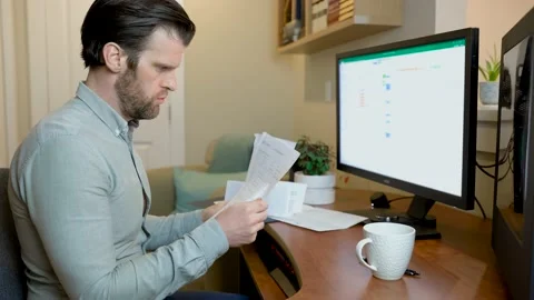 Man working from home on desktop computer bored tired and stressed with Stock Footage 152888243