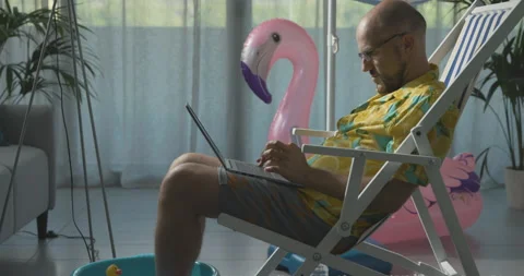 Man working from home during summer vacations Stock Footage 162389476