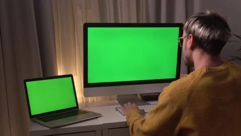 Man Working From Home On Green Screen Computer. Bearded man working on a green Stock Footage 142629233