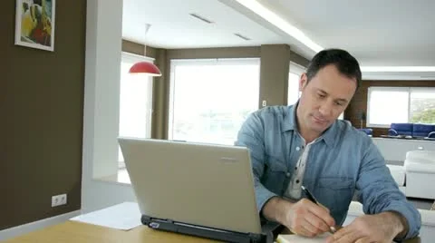 Man working at home on laptop computer Stock Footage 14823971