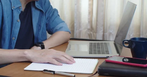 Man working from home with laptop computer with moody Stock Footage 129601402