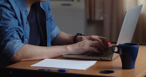 Man working from home with laptop computer and drink coffee Stock Footage 129602131