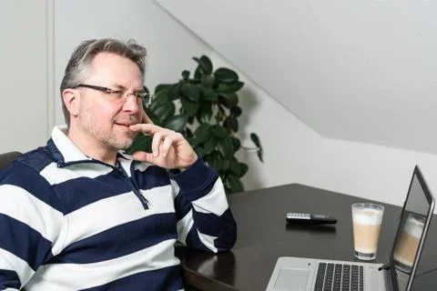 Man working from home on laptop computer Stock Photos