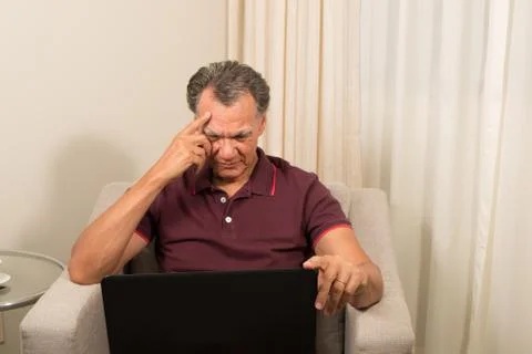 Man working from home on laptop computer Stock Photos