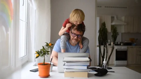 Man working from home with laptop during quarantine. Home office and parenthood. Stock Footage 128901614