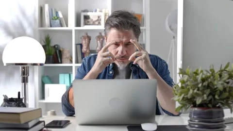 Man working home with laptop thinking Stock Footage 148022665