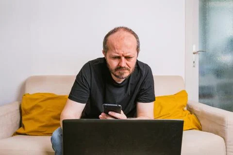 Man working from home office checking smart phone 스톡 사진