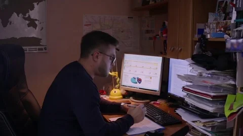 Man working at home office with graphics Stock Footage 83129262