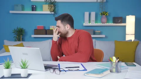 Man working from home scared and stressed because of what he sees on laptop. Stock-Footage 233104616