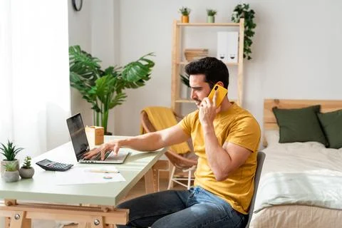 Man working from home with Tech. Stock Photos