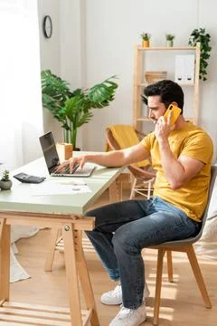 Man working from home with Tech. Stock Photos