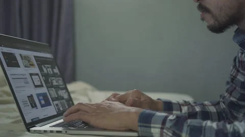 A man working from home use laptop in the bed room Stock Footage 146591719