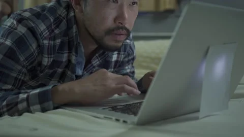 A man working from home use laptop in the bed room Stock Footage 146598148