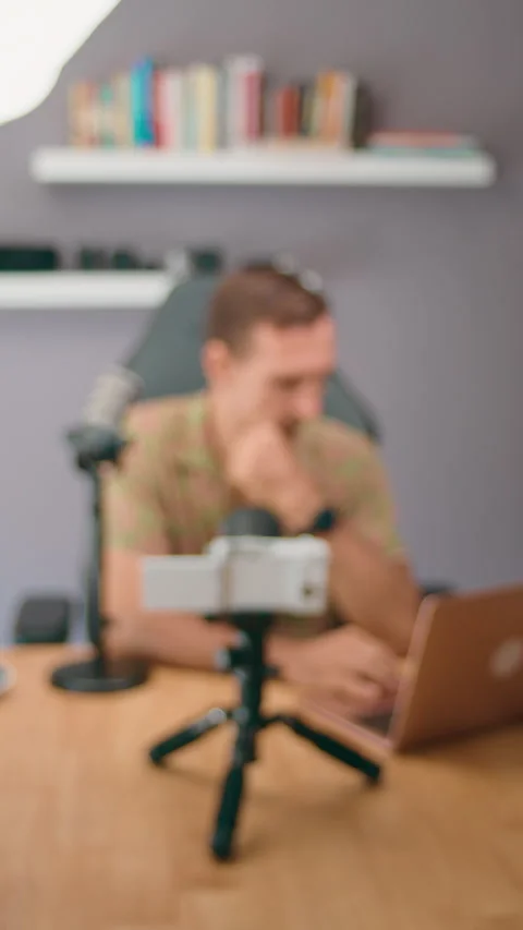 Man working from home, using laptop and microphone to create online video 스톡 동영상 276340731