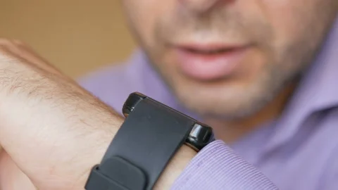 Man working from home using smart watch. Businessman talking to a smartwatch Stock Footage 90502129