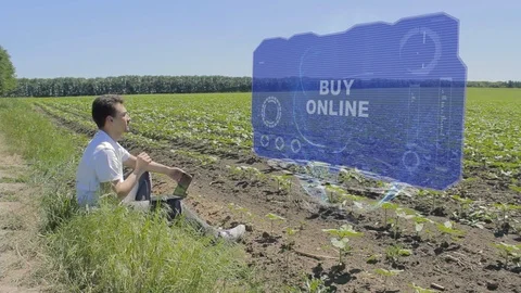 Man is working on HUD holographic display with text Buy Online on the edge of Stock Footage 104424029