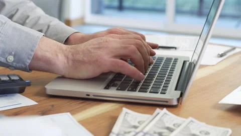 Man working on income tax return online. Stock Footage