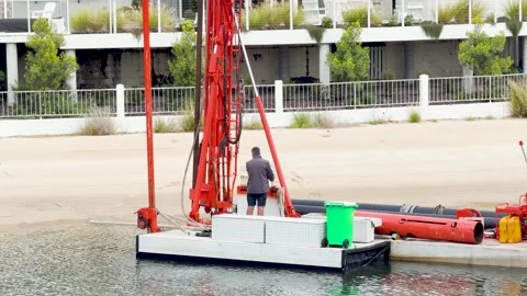 Man Working on Industrial Dredging Platform in Gold Coast Canal Stock Footage 334092815