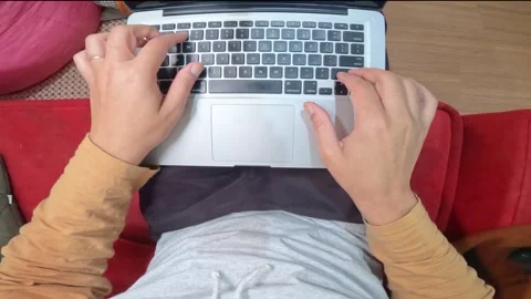 Man working on the internet with laptop in the living room at home. Home offi Stock Footage 305993385
