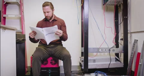 An man working in IT attempts to install a server Stock Footage 138664779