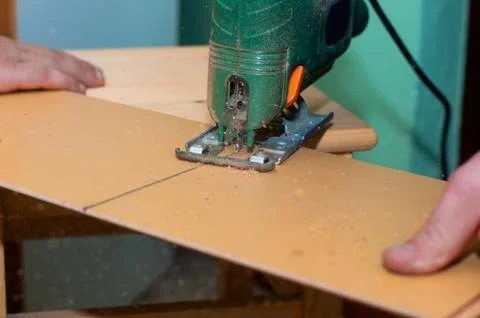 Man working with jig saw Stock Photos