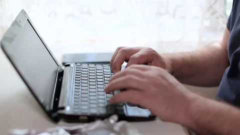 A man is working on a keyboard Stock Footage 90839958