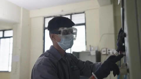 Man working in Lab Machine Warehouse Experiment Operating Machine with equip Stock Footage 322150579