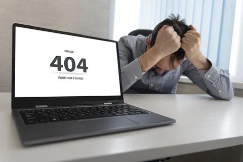 Man working on laptop, 404 error, the message on the screen page not found pr Stock Photos