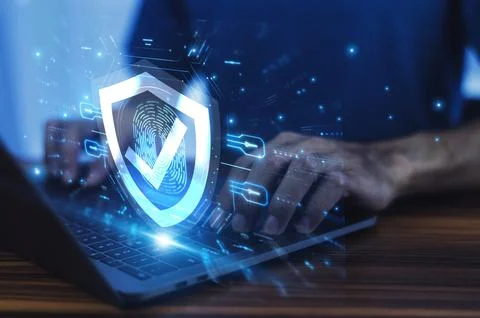 Man working on a laptop with advanced cyber security shield, ensuring the p.. Stock Photos