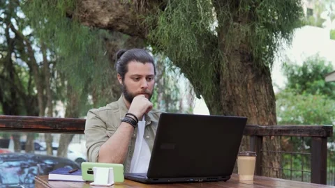 Man working with laptop and checking smart phone Stock Footage 152985384