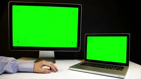 Man Working on the Laptop and Display with a Green Screen  at the Workplace. Видео 52107785