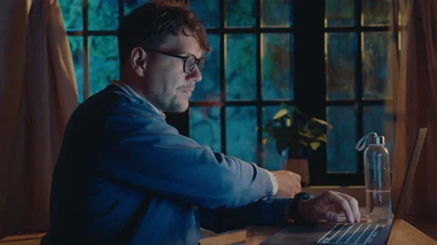 Man Working on Laptop and Drinking Tea in the Evening Video stock 237349457