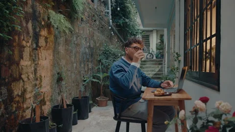 Man Working on Laptop and Drinking Tea in Outside the House Video stock 237349682
