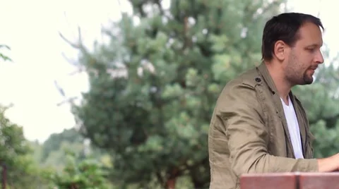 Man working on laptop and smiling, outdoors, dolly shot 스톡 동영상 8550201