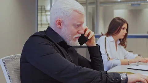 Man working on the laptop and talking on the phone 스톡 동영상 101744723