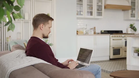 Man working on laptop and talking to little daughter at home Stock Footage 127657421
