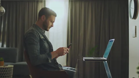 Man working on laptop and using mobile 스톡 동영상 234347509