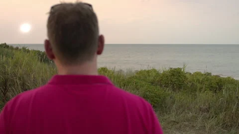 Man working with a laptop by the beach Reverse Stock Footage 132904490
