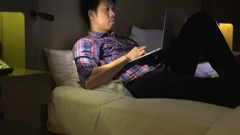 Man Working on Laptop in Bed Stock Footage 314612185