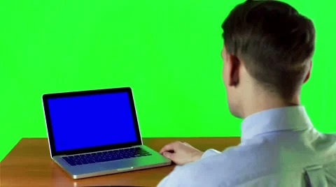 Man working at a laptop with blue screen with various hand gestures 스톡 동영상 49684933