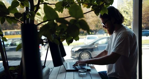 Man Working on Laptop in Cafe Window Silhouette Видео 116315483