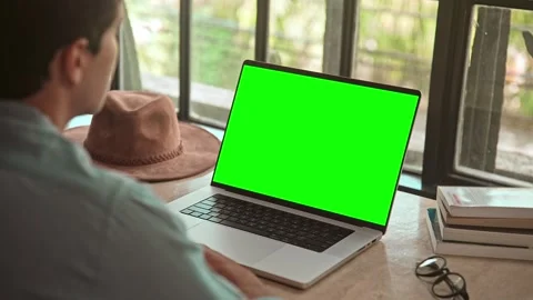 Man Working on Laptop Computer and Looking at Online Video Call on Green Screen Stock Footage 258644231