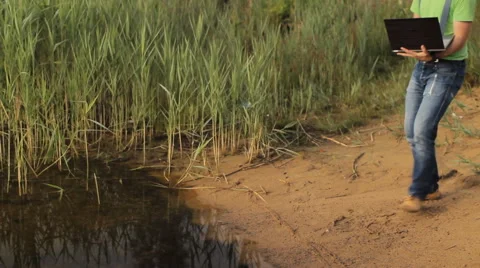 A man working on a laptop computer at the coast Stock Footage 64660128